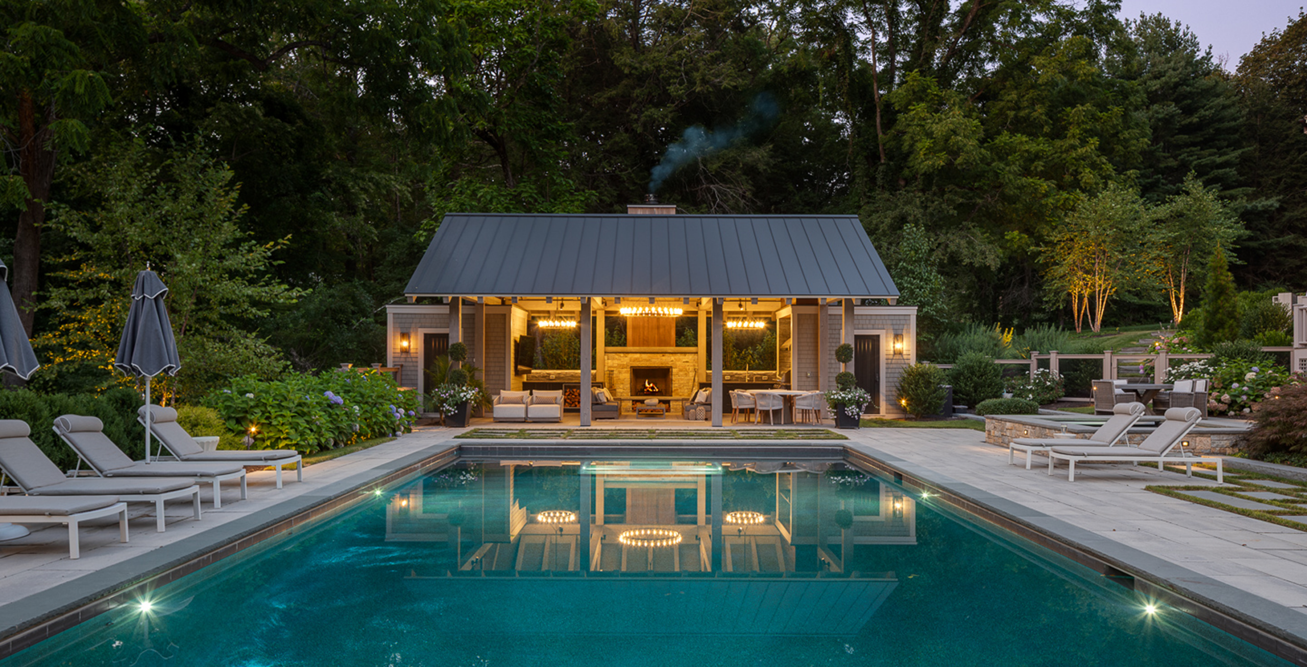 Suburban Transitional Pool House at dusk